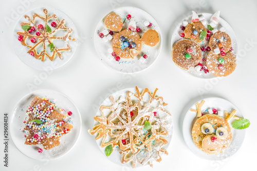 Various funny kid Christmas breakfast pancakes set - in form of snowflakes, Christmas tree, snowman, santa deer, mouse, With xmas decoration copy space