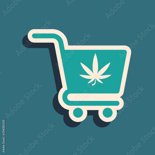 Green Shopping cart with marijuana or cannabis leaf icon isolated on blue background. Online buying. Delivery service. Supermarket basket. Long shadow style. Vector Illustration