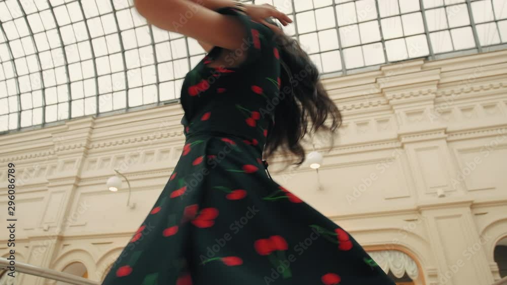 Happy brunetеe girl in dress whirls around in dance and smiles. Happiness concept. Slow motion Happy brunetеe girl in dress whirls around in dance and smiles. Happiness concept. Slow motion