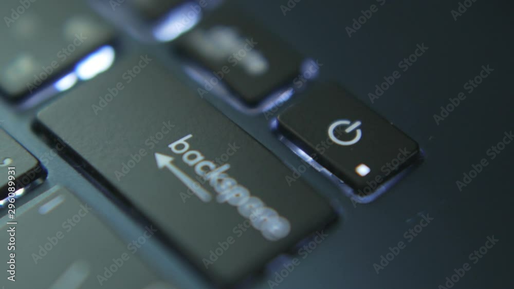 Index finger pressing on power button on laptop. Index finger pressing on power button on laptop.