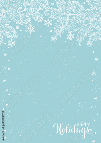 Winter holidays or Christmas background with pine branches and snowflakes.