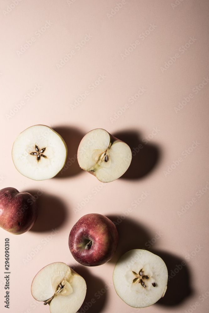 Apples and apple slices on pastel background. Top view shot, abstract food conception. Apples and apple slices on pastel background. Top view shot, abstract food conception.