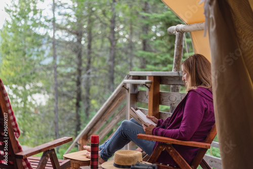 glamping trip - woman sitting and relaxing outside luxury tent in Montana © David Prahl