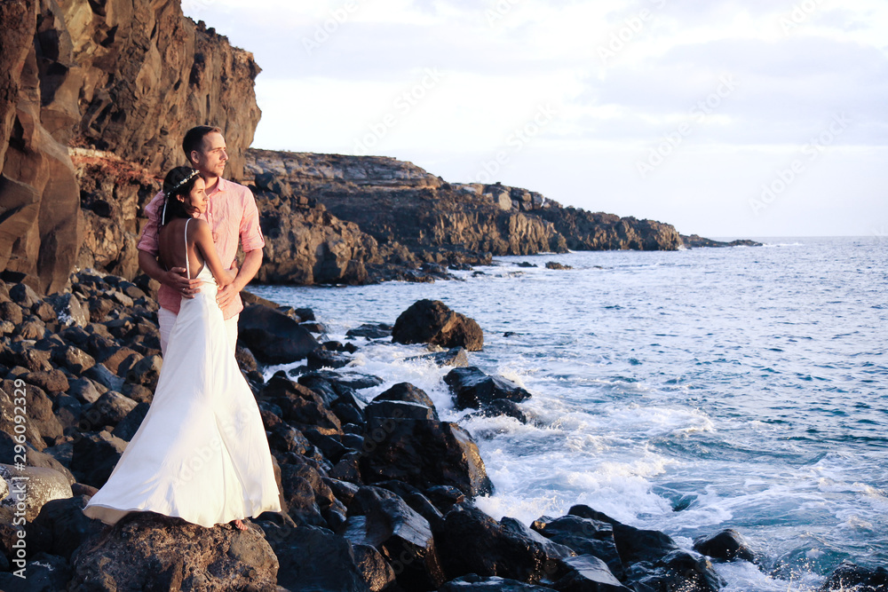 Happy couple just married at the oceanside Happy couple just married at the oceanside