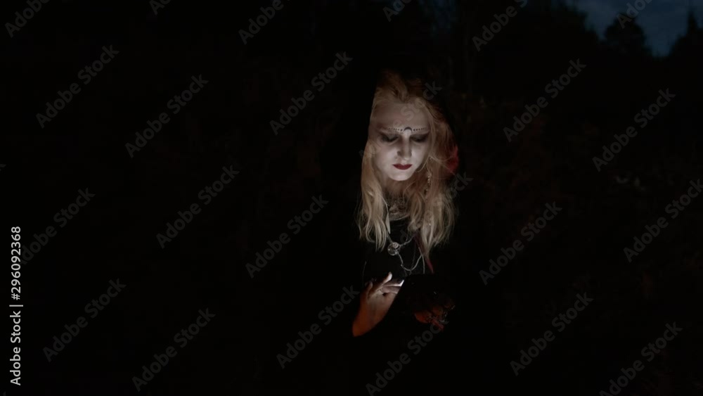 Ggirl In The Image Of Witch Uses Mobile Phone. Halloween. Ggirl In The Image Of Witch Uses Mobile Phone. Halloween.