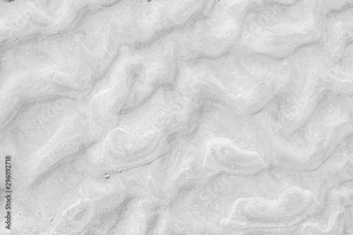 A top down shot of a white river sand bottom full of texture and salt marks. Useful as abstract background.