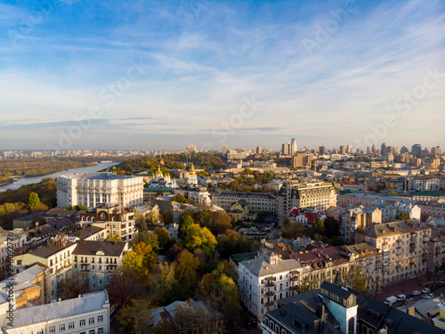Aerial top view of Kyiv cityscape, Dnieper river and Podol historical district skyline from above, Kontraktova square with ferris wheel, city of Kiev, Ukraine