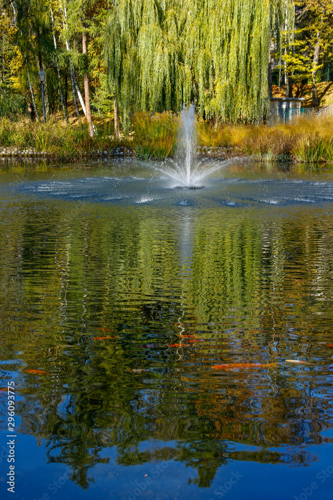 fountain in an autumn park fountain in an autumn park