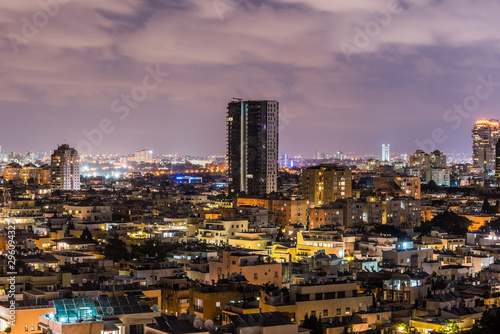 Night aerial view of Tel Aviv City with modern skylines and luxury hotels at the beach near the Tel Aviv port in Israel.