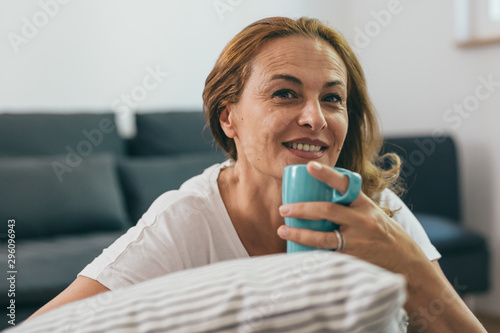 portrait of mid aged woman holding cup of coffee
