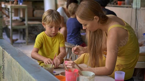 Slowmotion shot of a little boy and his mother on a pottery master class