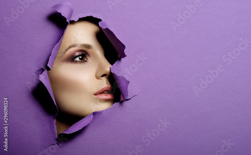 woman looks in hole colored...