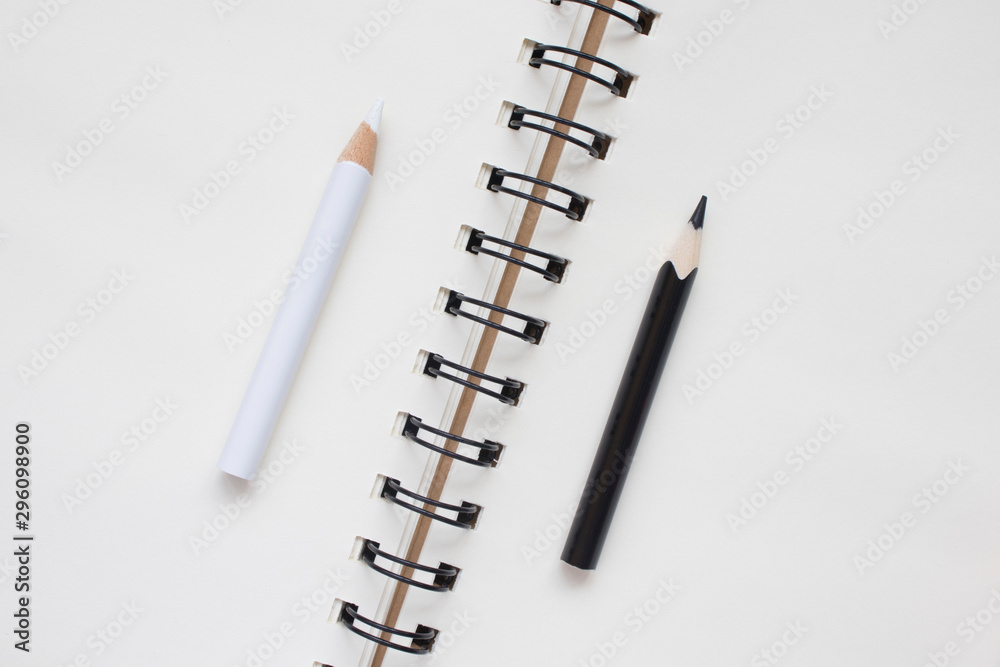 white and black pencil on Notepad, business concept, top view, copy space white and black pencil on Notepad, business concept, top view, copy space