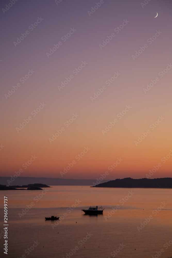 Beautiful tranquil pink and orange sunset over the sea horizon