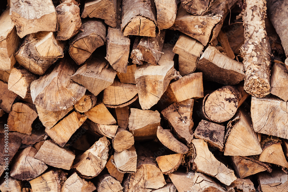 Close-up wooden logs folded in the form of woodpile lie on the street. Concept of rustic background and country life Close-up wooden logs folded in the form of woodpile lie on the street. Concept of rustic background and country life