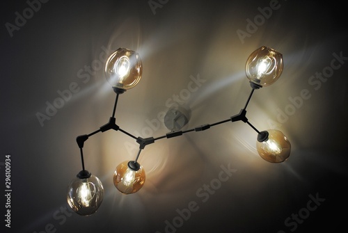 Chandelier molecule for lighting a small room. Beige shades on the ceiling chandelier.
