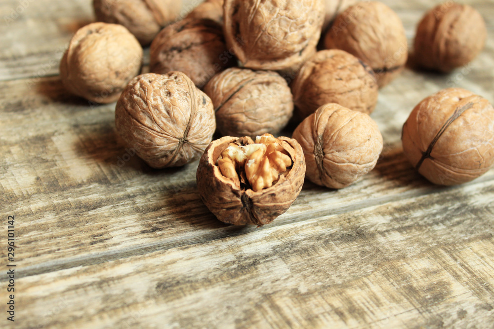 Walnuts close-up on a wooden background. One nut is chopped. Walnuts close-up on a wooden background. One nut is chopped.