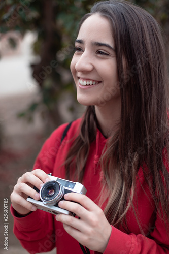Smiling girl holding a vintage camera