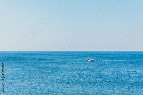 Boat on blue sea surface aerial view. Nature background © hdesert