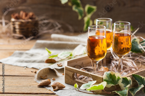 Fotomurale Italian almond liquor amaretto on a wooden table