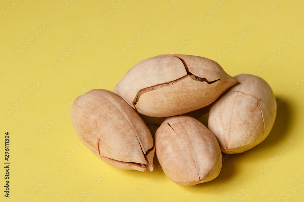 Background: pecan on a yellow background Background: pecan on a yellow background
