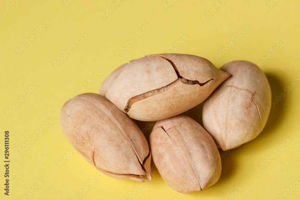 Fototapeta premium Background: pecan on a yellow background