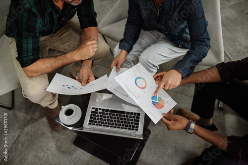 Aerial view of diverse business team analyzing financial data
