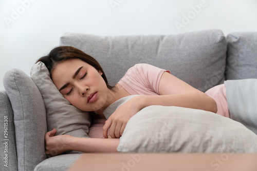 Beautiful asian young woman relaxing and sleeping on sofa in the living room at home