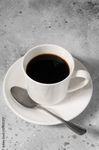 A white Cup of coffee on a gray table 