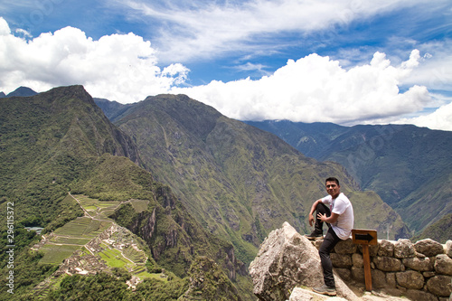 Traveller at the Lost city of the Incas, Machu Picchu,Peru on top of the mountain, with the view panoramic