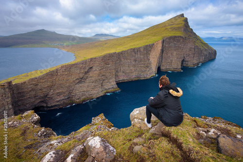 Hiker looking at the lake Sorvagsvatn on Faroe Islands photo