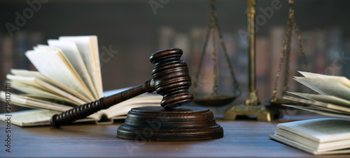 Law and Justice concept. Mallet of the judge, books, scales of justice. Courtroom theme. photo