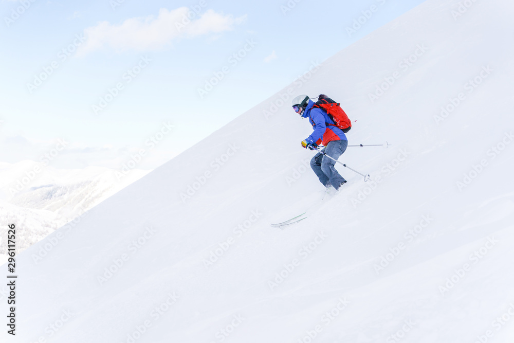 Side photo of athlete man with backpack skiing