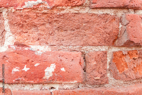 Red grunge brick background. Old brick wall texture of red stone blocks closeup