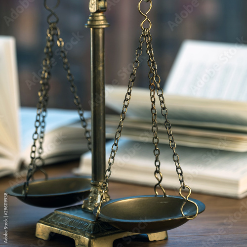 Law and Justice concept. Mallet of the judge, books, scales of justice. Courtroom theme.