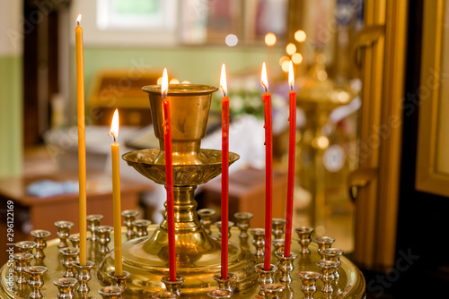 symbol of faith and Christianity: a candlestick with burning candles in the temple