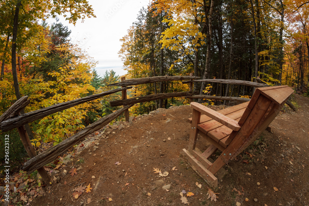 Bench facing the river and islands in autumn hiking park, Canada