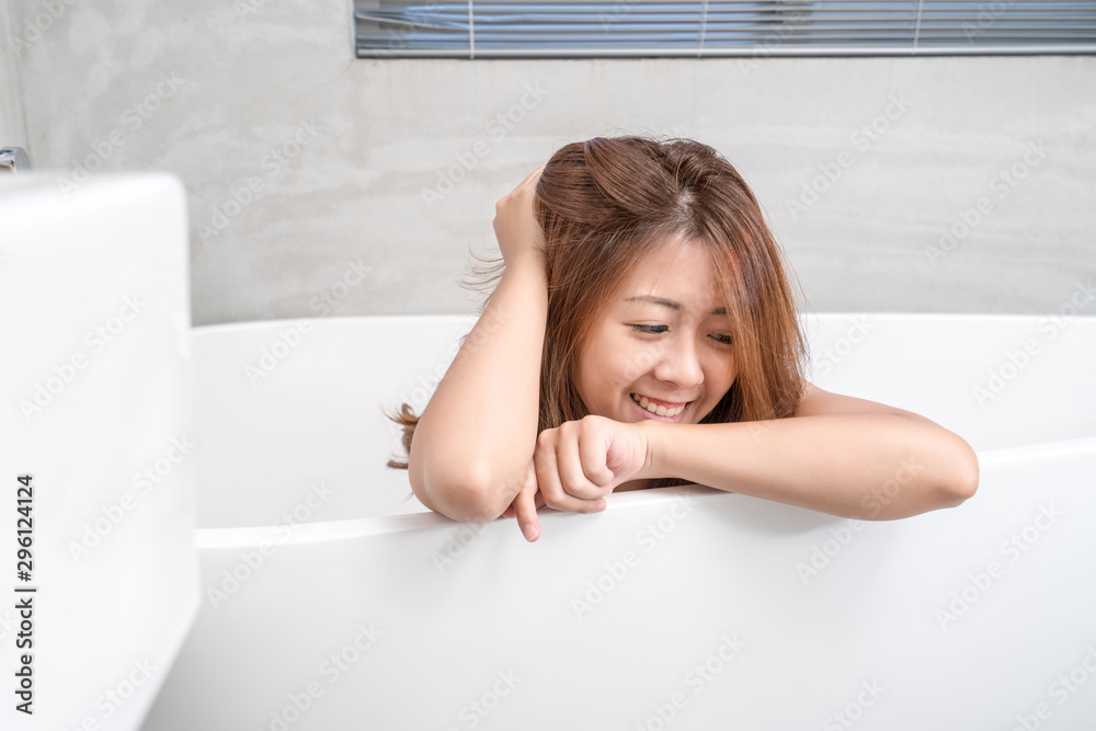 Portrait of young attractive asian girl takes a bath with candles relax in the bathroom. Beauty woman in spa treatments. Healthy perfect glow skin care concept Portrait of young attractive asian girl takes a bath with candles relax in the bathroom. Beauty woman in spa treatments. Healthy perfect glow skin care concept