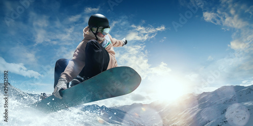 Snowboarder in action. Extreme winter sports. photo