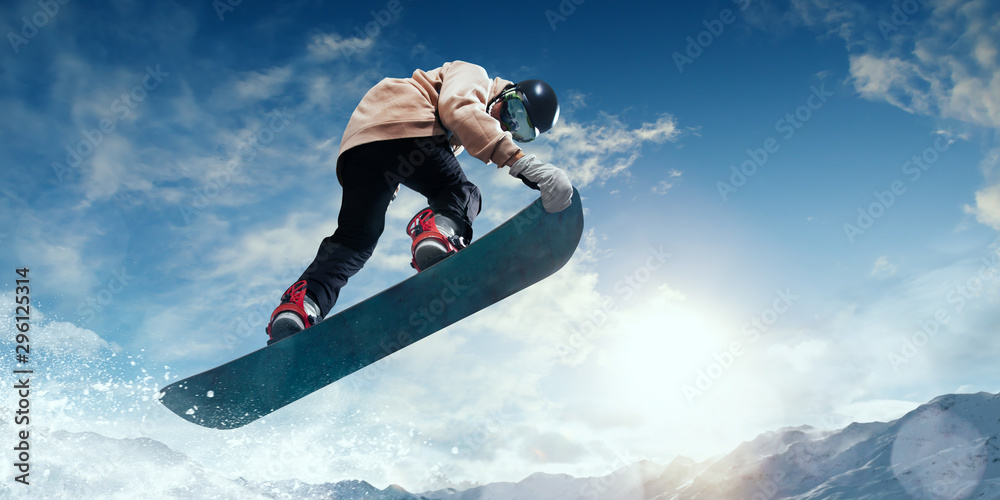 Snowboarder in action. Extreme winter sports. - obrazy, fototapety, plakaty 