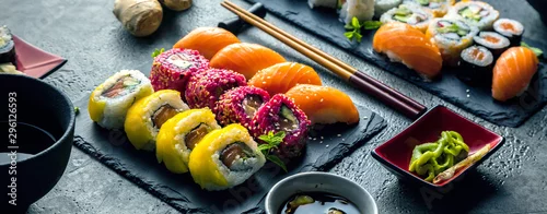 Obraz  z motywem  Sushi Set Sashimi und Sushirollen auf Steinschiefer serviert