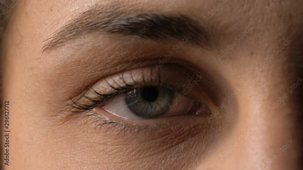 young woman closed eye opening and looking at camera young woman closed eye opening and looking at camera