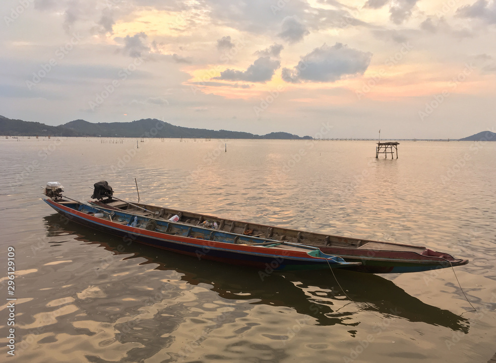 Naklejka premium Artisanal fisheries boat with sunset sky at the Songkhla lake, Thailand