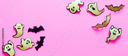 Happy halloween holiday concept. Halloween decorations  pumpkins  bats  candy  ghosts  bugs on pink background. Halloween party greeting card mockup with copy space. Flat lay  top view  overhead.