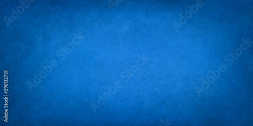 Blue background texture, old vintage textured paper or wallpaper with painted elegant solid blue color with dark black vignette border