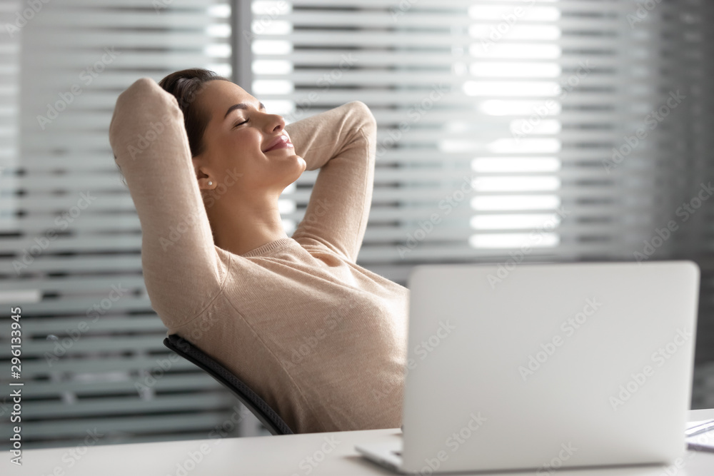 Satisfied businesswoman relaxing in comfortable office chair during break Satisfied businesswoman relaxing in comfortable office chair during break