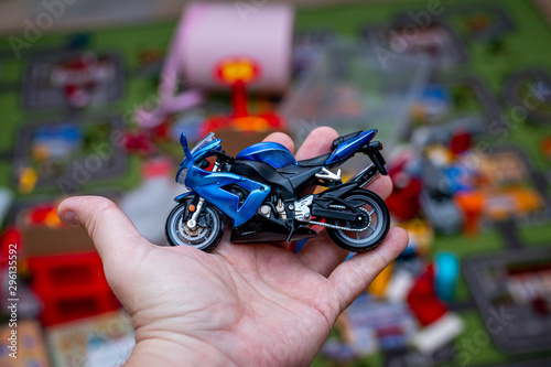 Cool toy speed bike in man hand.