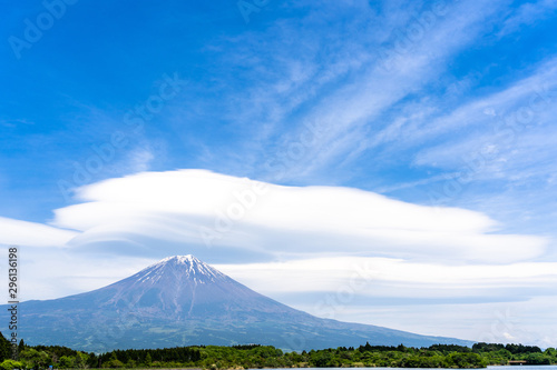 Fuji mountain with cloudy hat on top   fantastic clouds blue sky background spot view at Lake Tanuki  Tanuki-ko  in morning time near small hill and green forest foreground  Fujinomiya Shizuoka Japan.