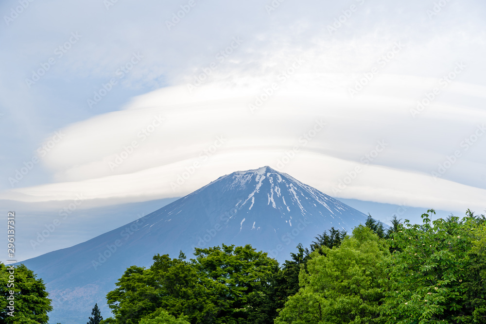 Mount Fuji with cloudy hat on top , vertical close up with amazing clouds on blue sky background, beautiful in morning time in Fujinomiya, Shizuoka ,Japan