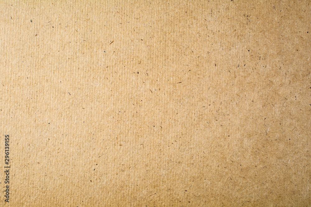 The texture of the old light brown cardboard surface close-up. The texture of the old light brown cardboard surface close-up.